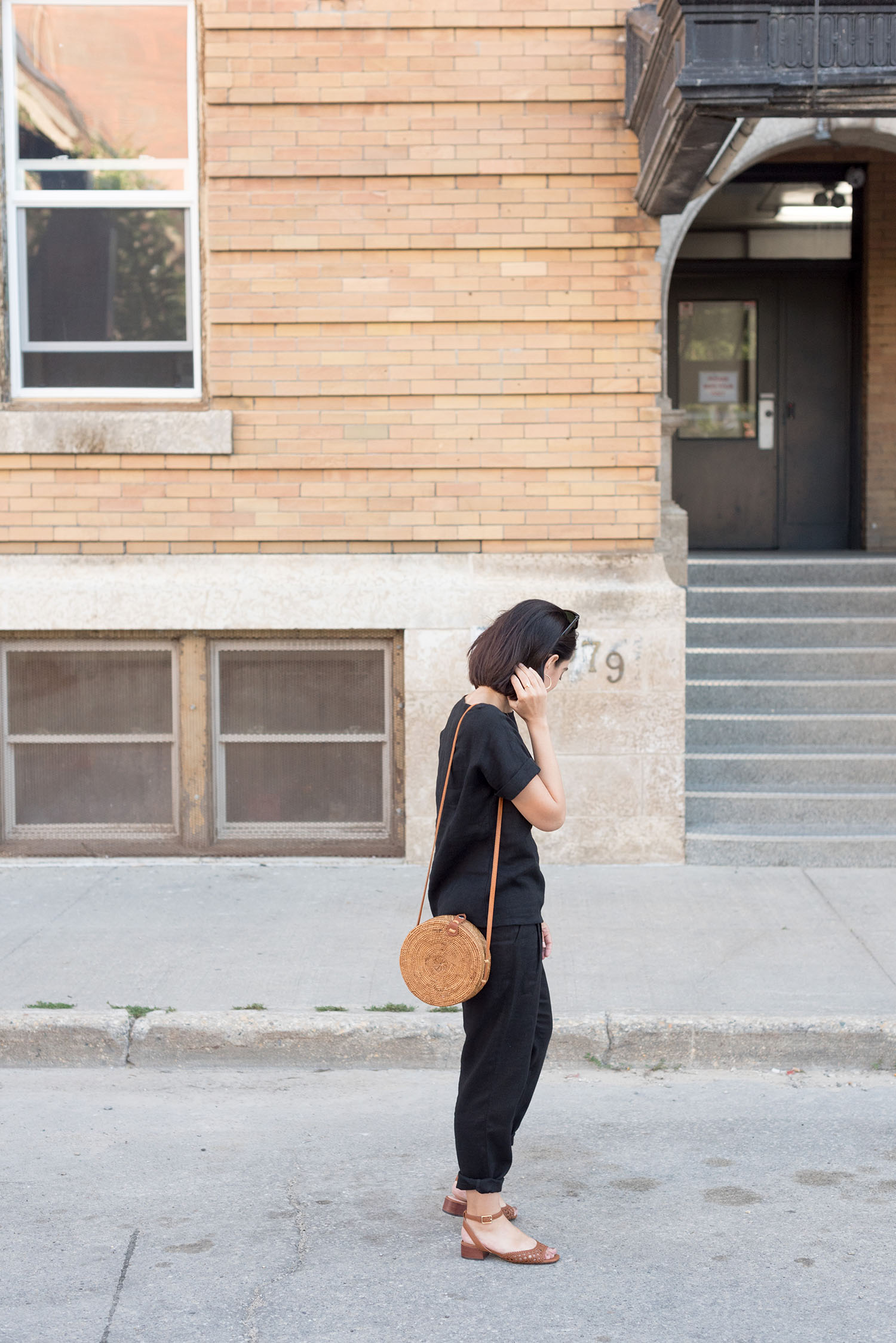 Top Canadian fashion blogger wears a black linen suit from Ode to Sunday in the Winnipeg Exchange District