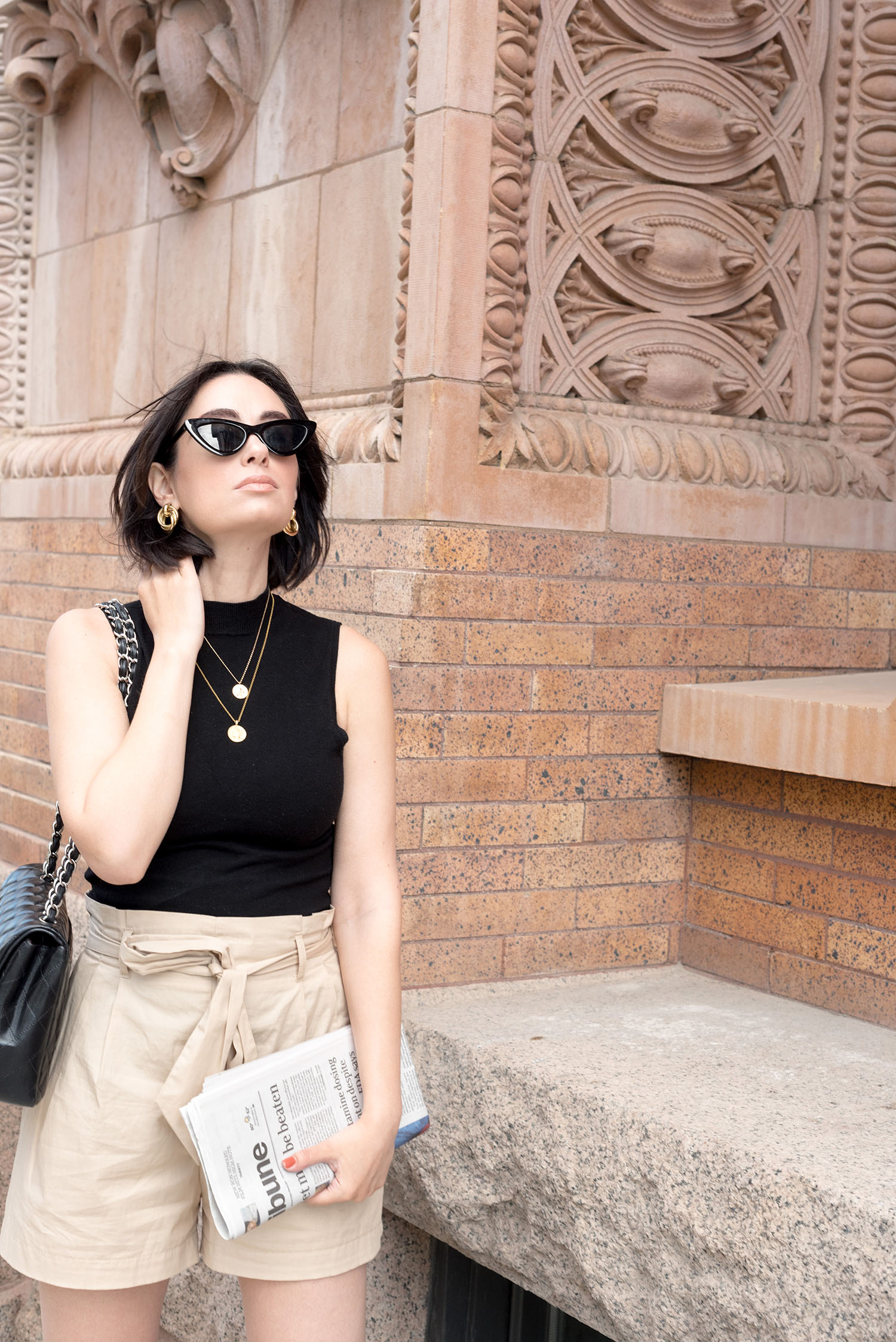 Portrait of top Canadian fashion blogger Cee Fardoe of Coco & Vera, talking about how to restyle your wardrobe while wearing Mango hoop earrings and Zara cat eye sunglasses