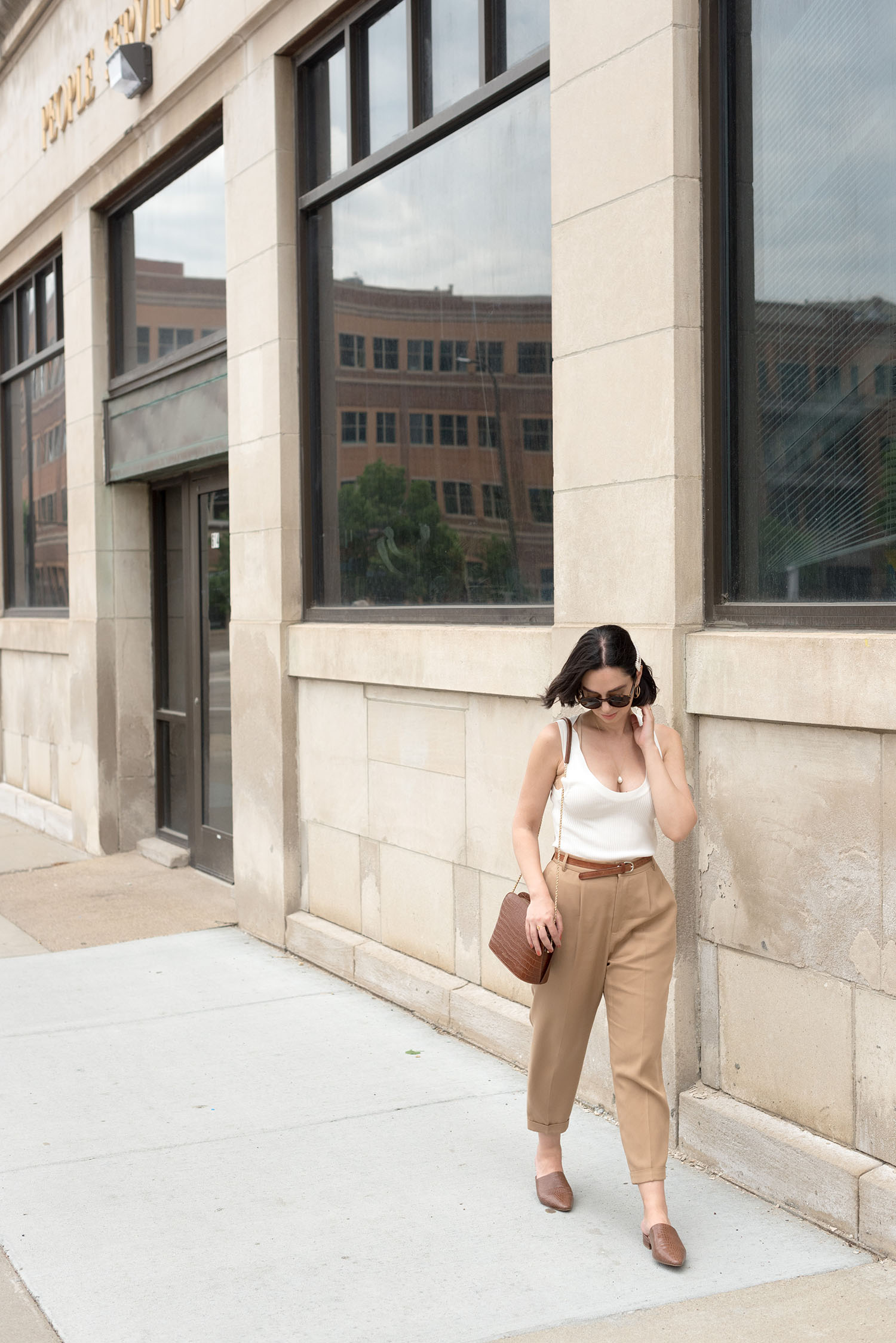 Top Canadian fashion blogger Cee Fardoe of Coco & Vera wears Zara trousers and carries a Sezane Victor handbag in Minneapolis