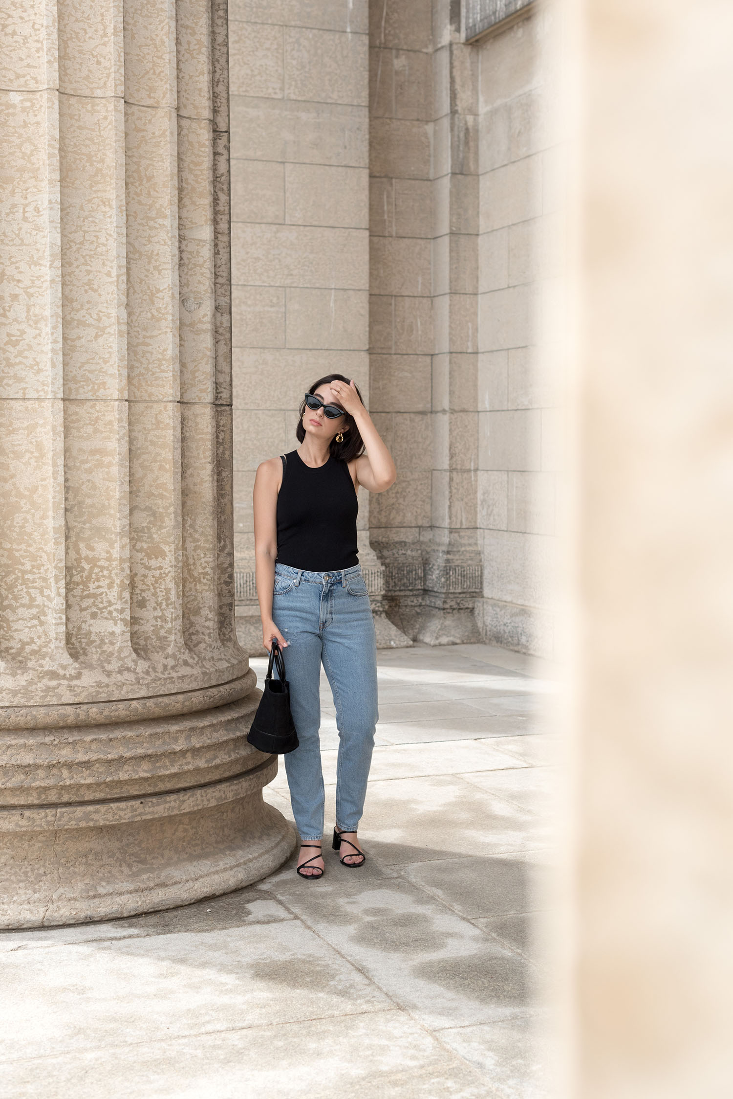 Top Winnipeg fashion blogger Cee Fardoe of Coco & Vera wears Zara mom fit jeans and a racer back tank at the Manitoba Legislature, while talking about a disconnect to her city