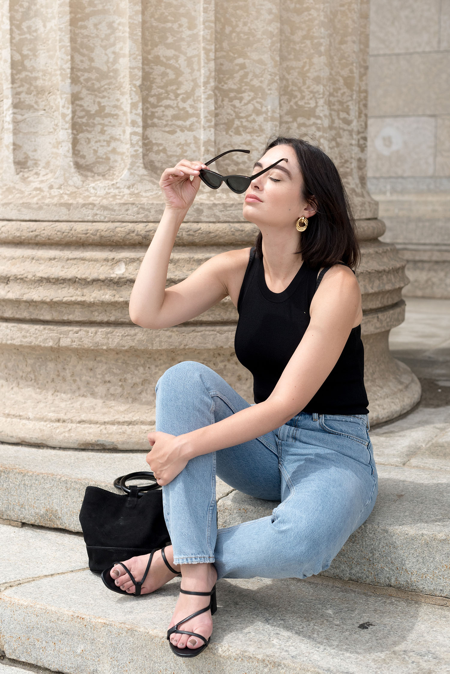 Top Winnipeg style blogger Cee Fardoe of Coco & Vera puts on Zara cat eye sunglasses while wearing Zara mom jeans
