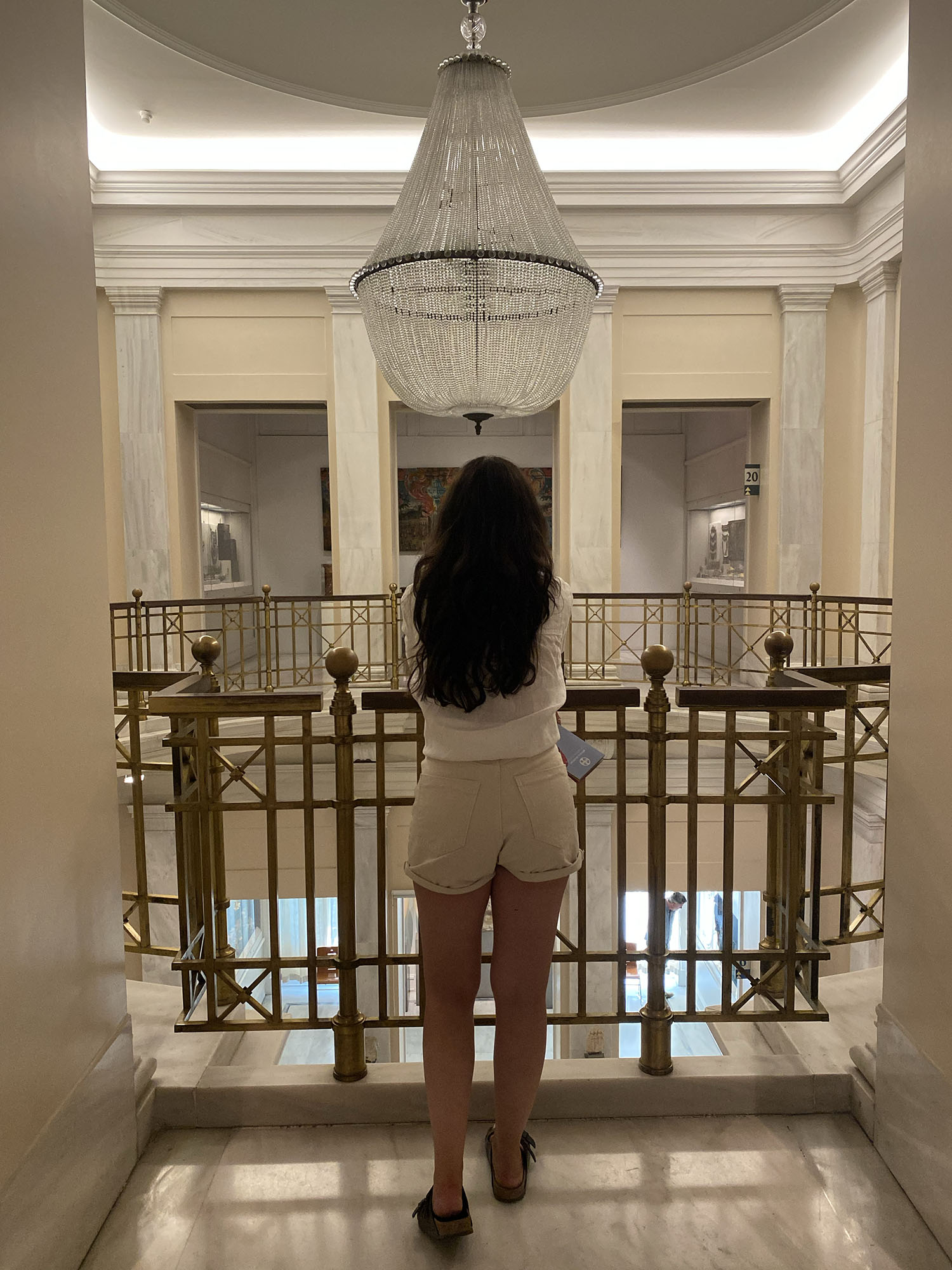 Coco & Vera - Cee Fardoe looks over the chandelier at the Benaki Museum in Athens