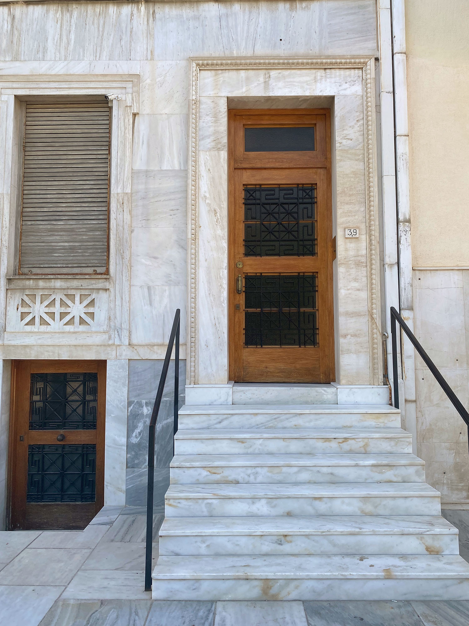 Coco & Vera - Wooden door on marble building in Plaka, Athens