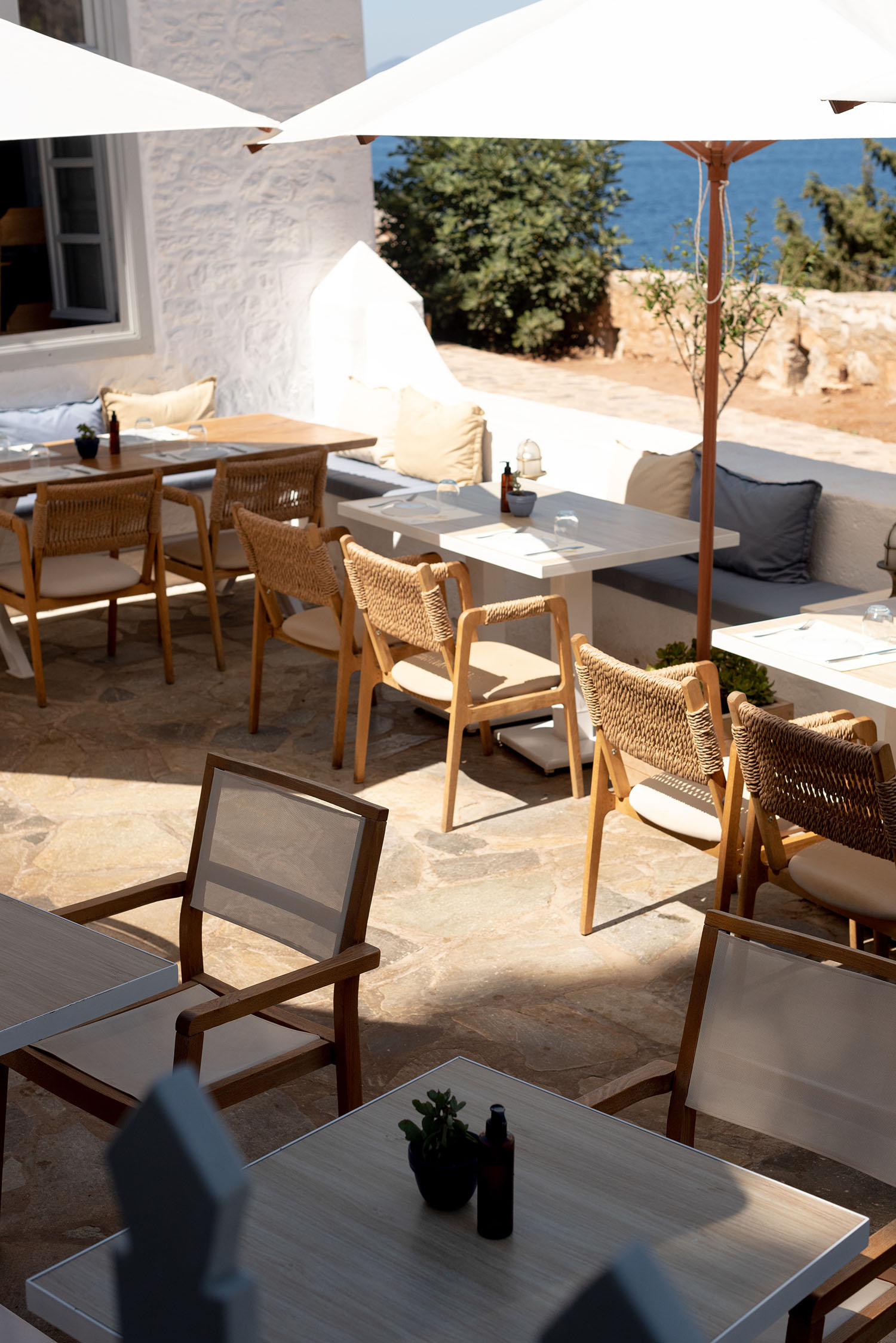 Coco & Vera - Blue and white patio seating on the terrace at Techne Restaurant in Greece
