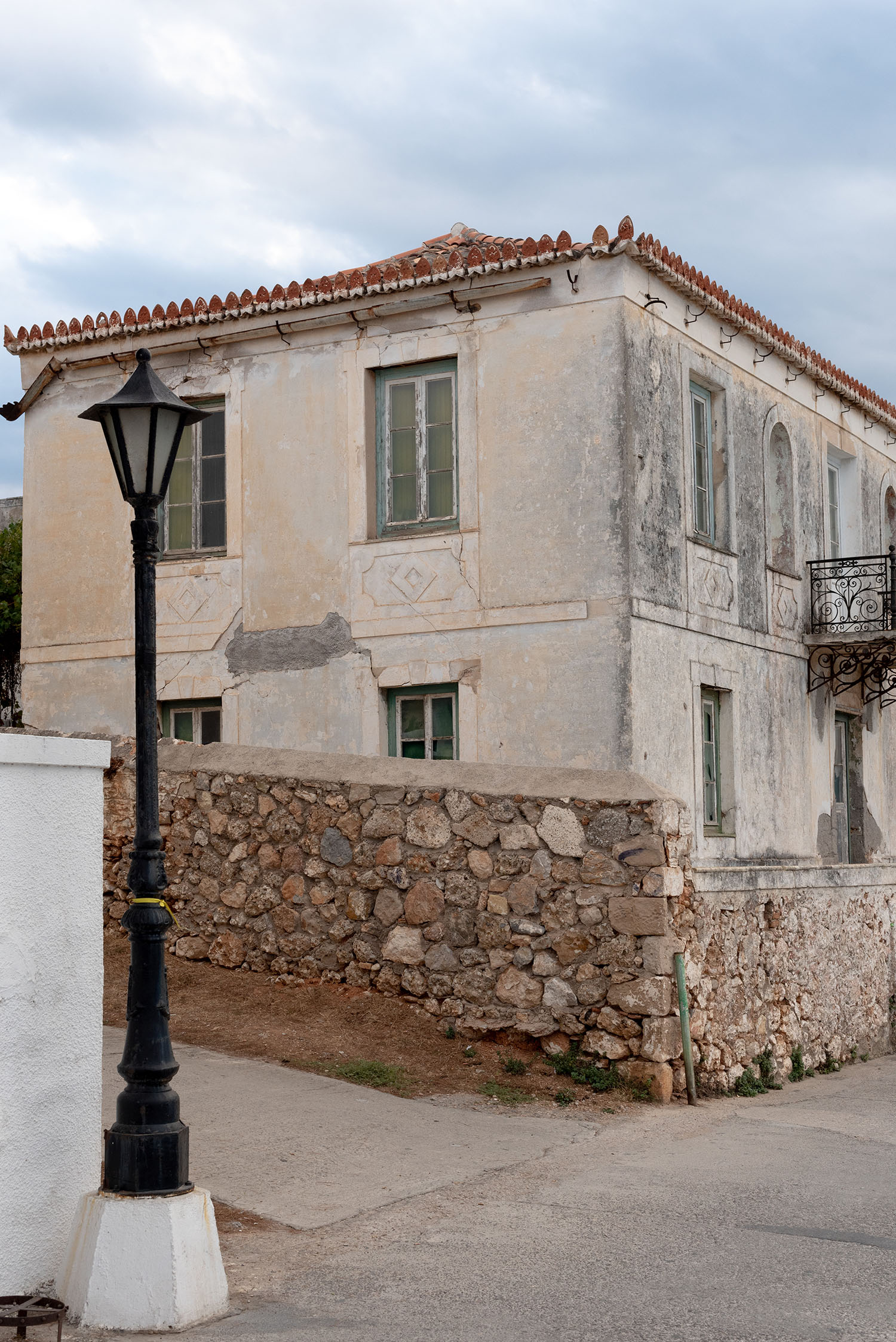 Coco & Vera - Beige house with green shutters on Spetses, Saronic Islands, Greece