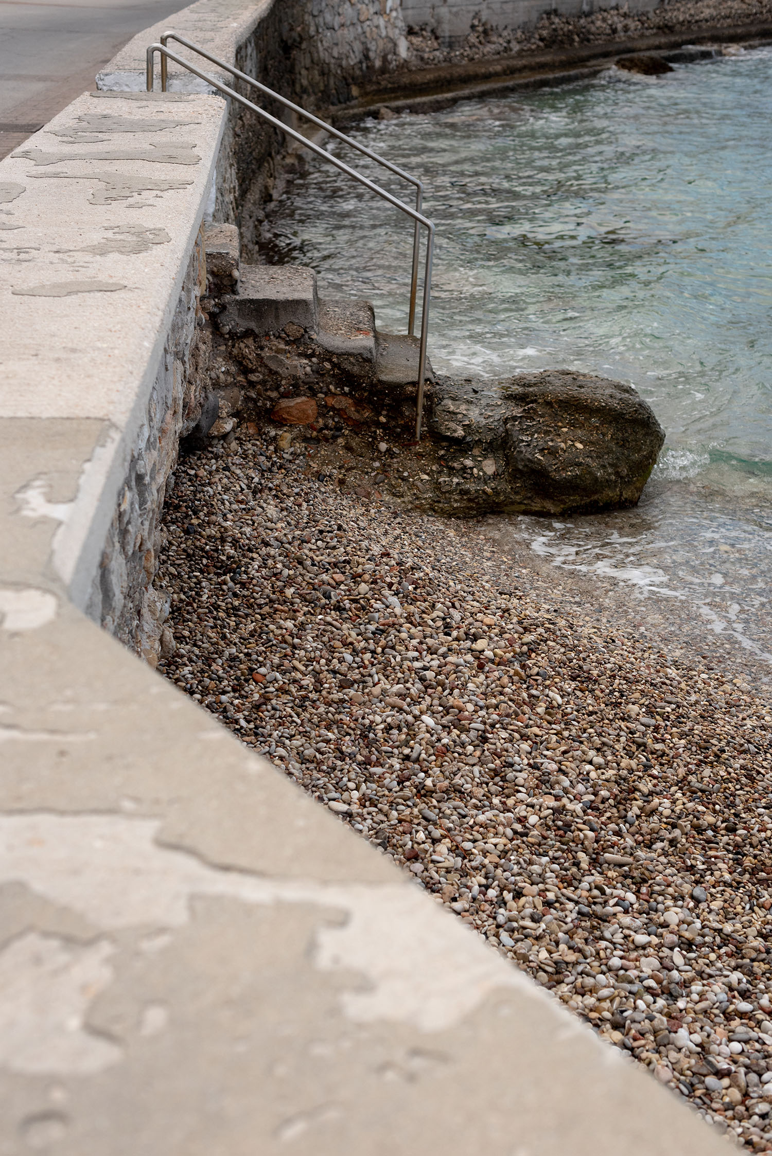 Coco & Vera - Stone stairs into the sea at a rocky beach on Spetses Island