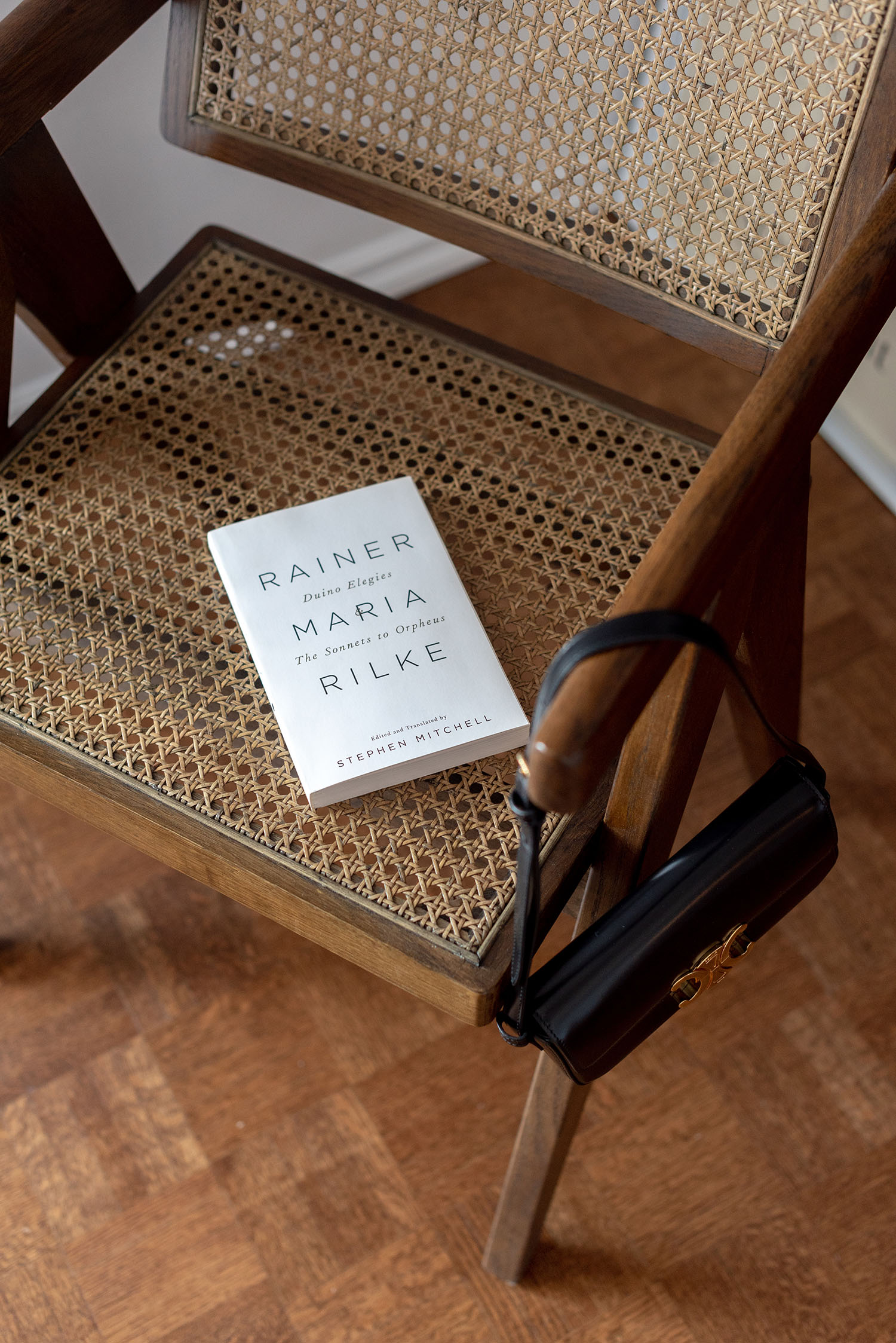 Coco & Vera - Eiffel chair, Rainer Maria Rilke book, Celine Triomphe shoulder bag