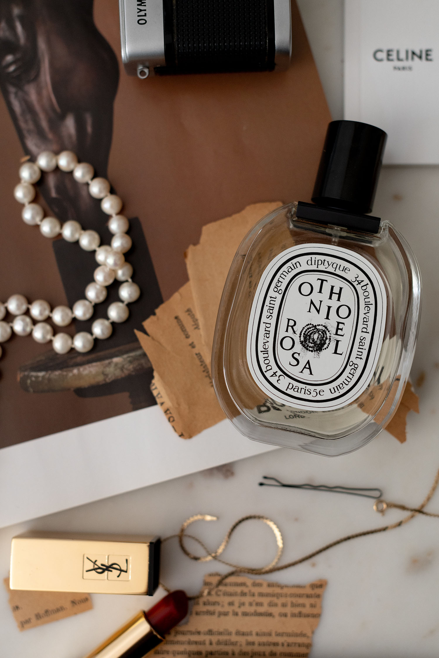 Coco & Voltaire, Diptyque Othoniel Rosa perfume, YSL red lipstick, Pearl necklace