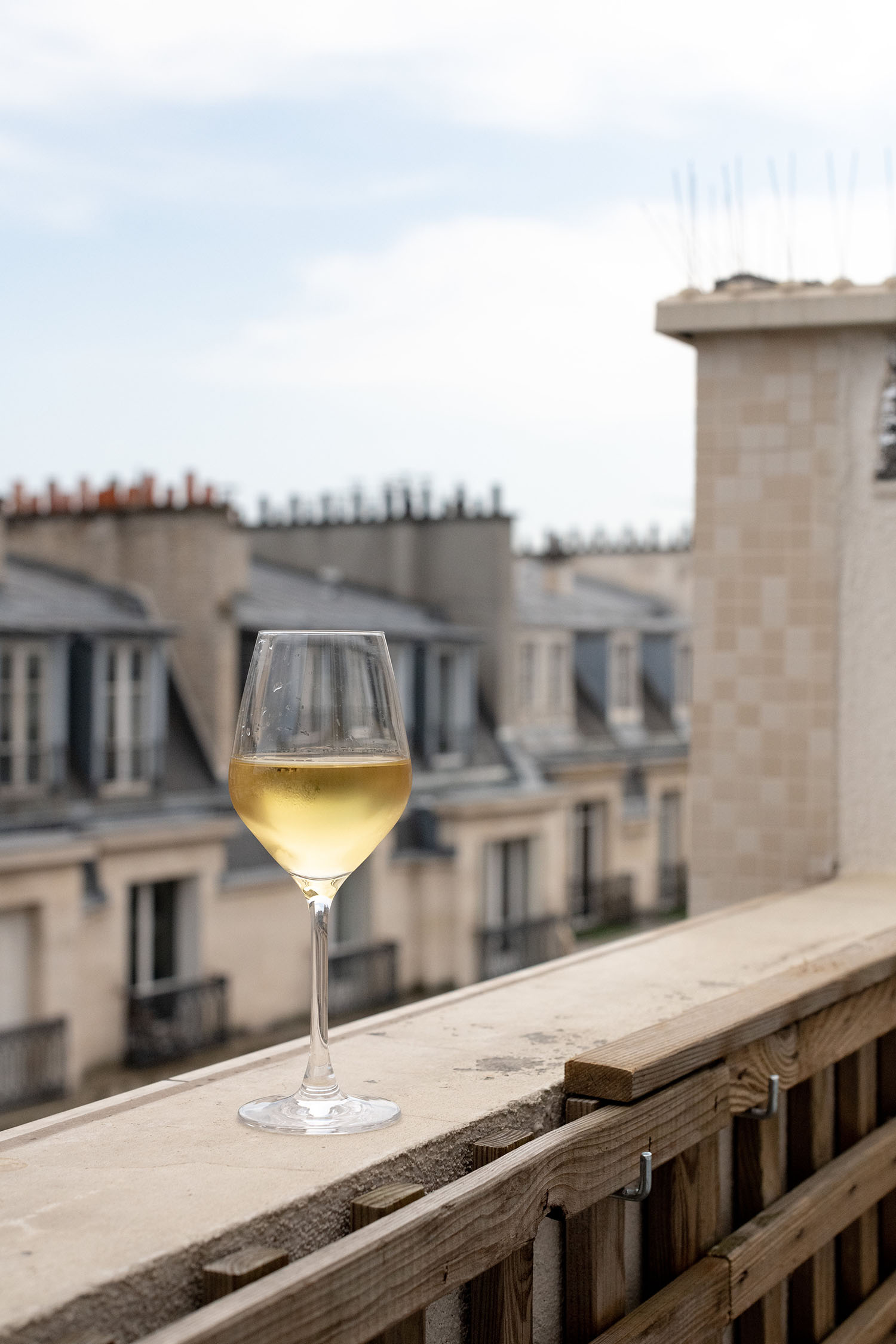 Coco & Voltaire - Glass of white wine on a balcony ledge in the sixteenth arrondissement of Paris