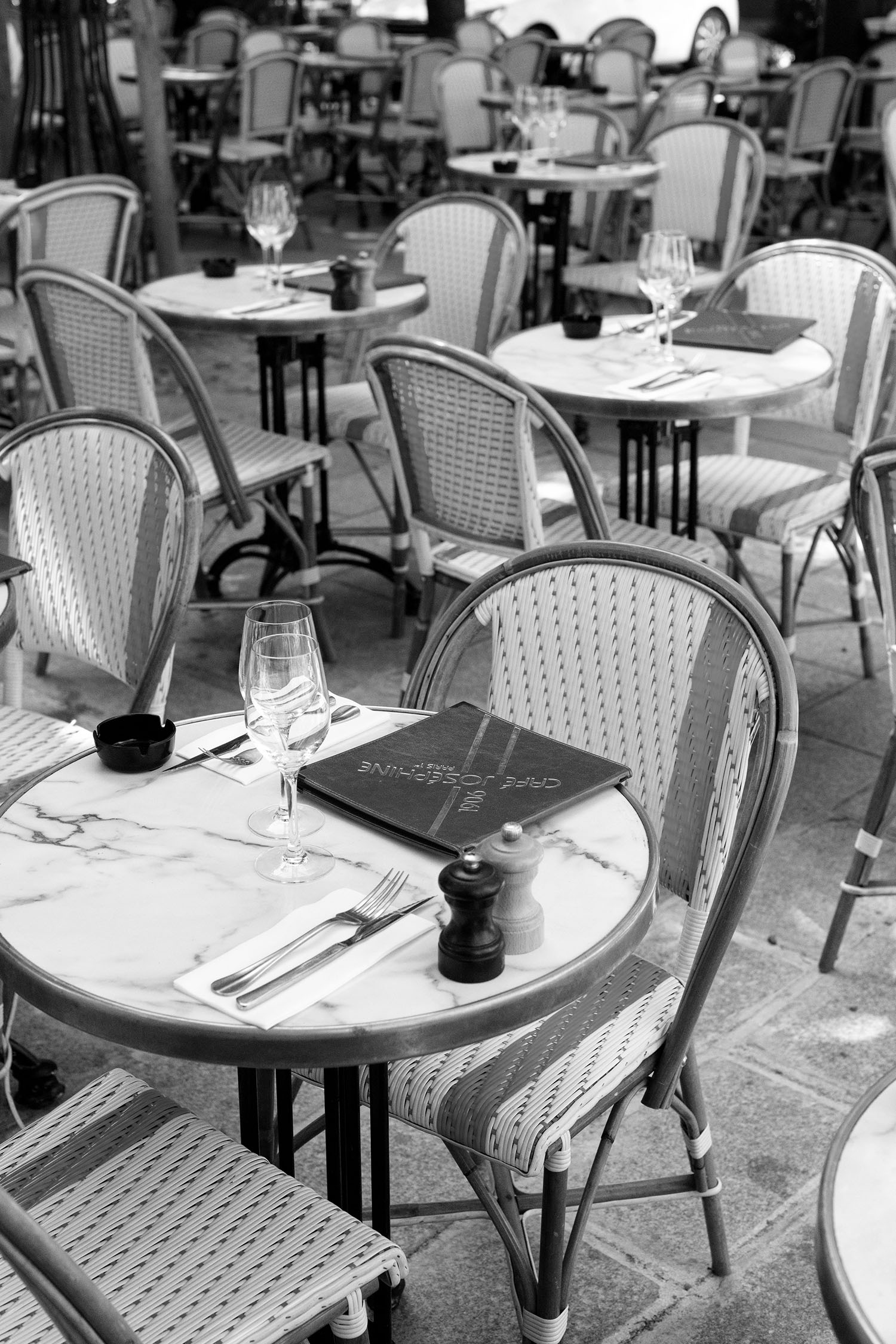 Coco & Voltaire - Tables and chairs on the terrace at Chez Josephine in Paris, France