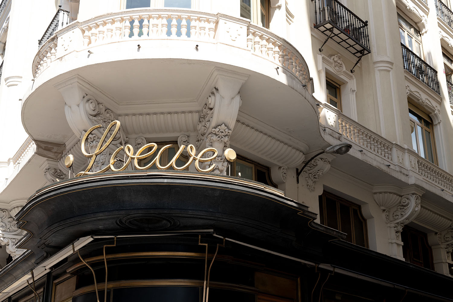 Coco & Voltaire - Loewe boutique sign on Gran Via in Madrid