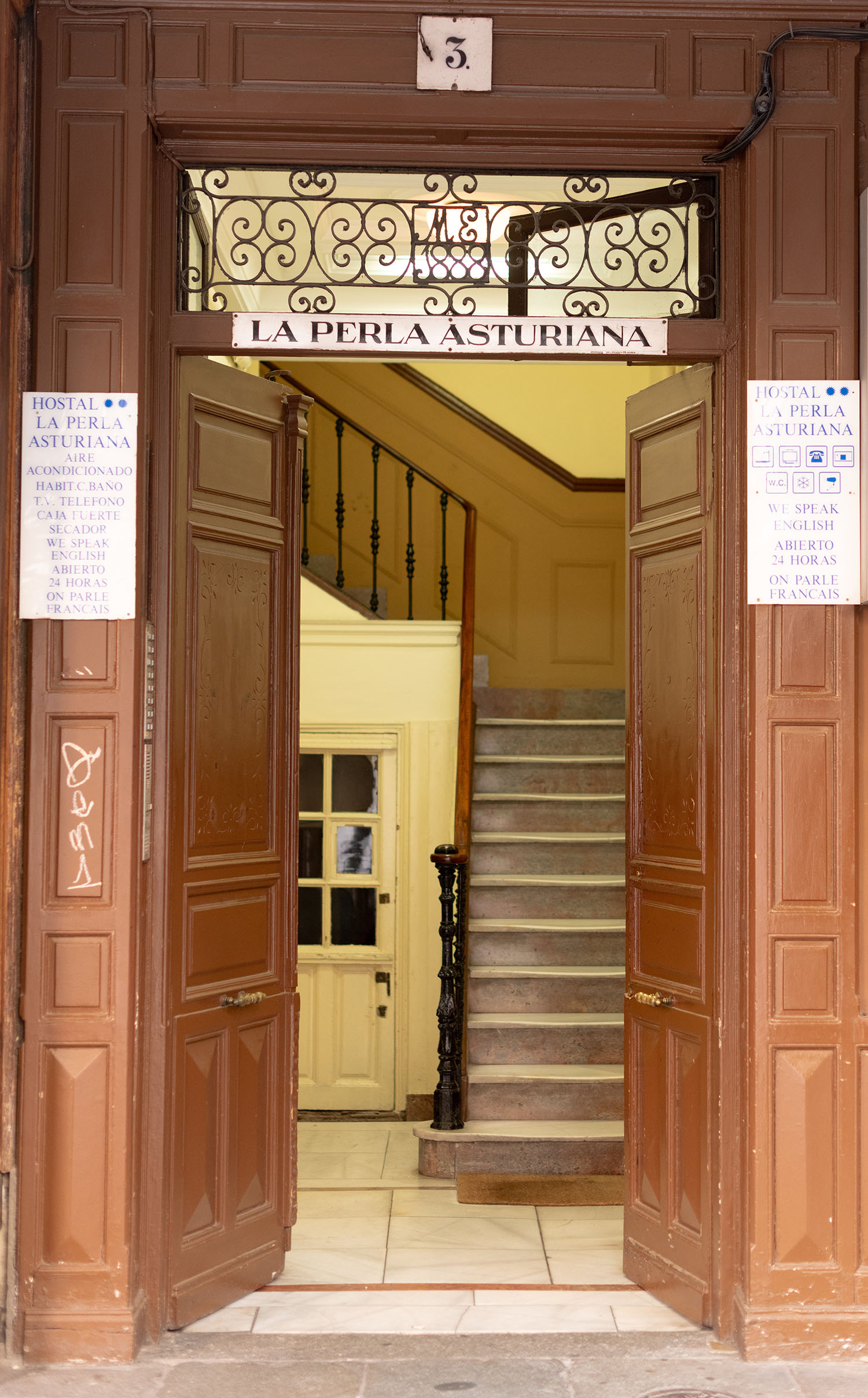 Coco & Voltaire - Entryway to La Perla Asturiana Hostel in Madrid, Spain
