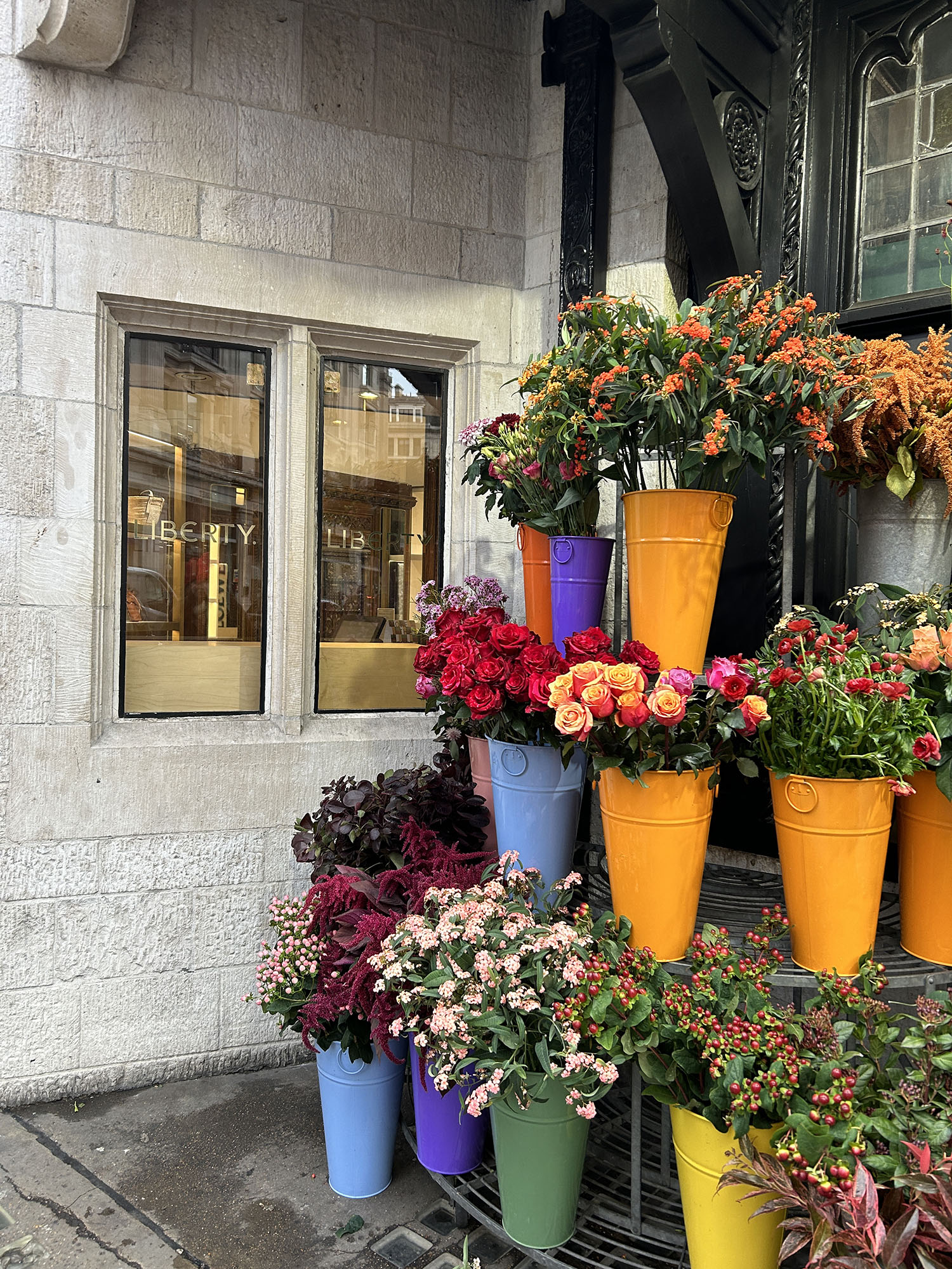 Coco & Voltaire - Vibrant bouquets of flowers in colourful pots outside Liberty London
