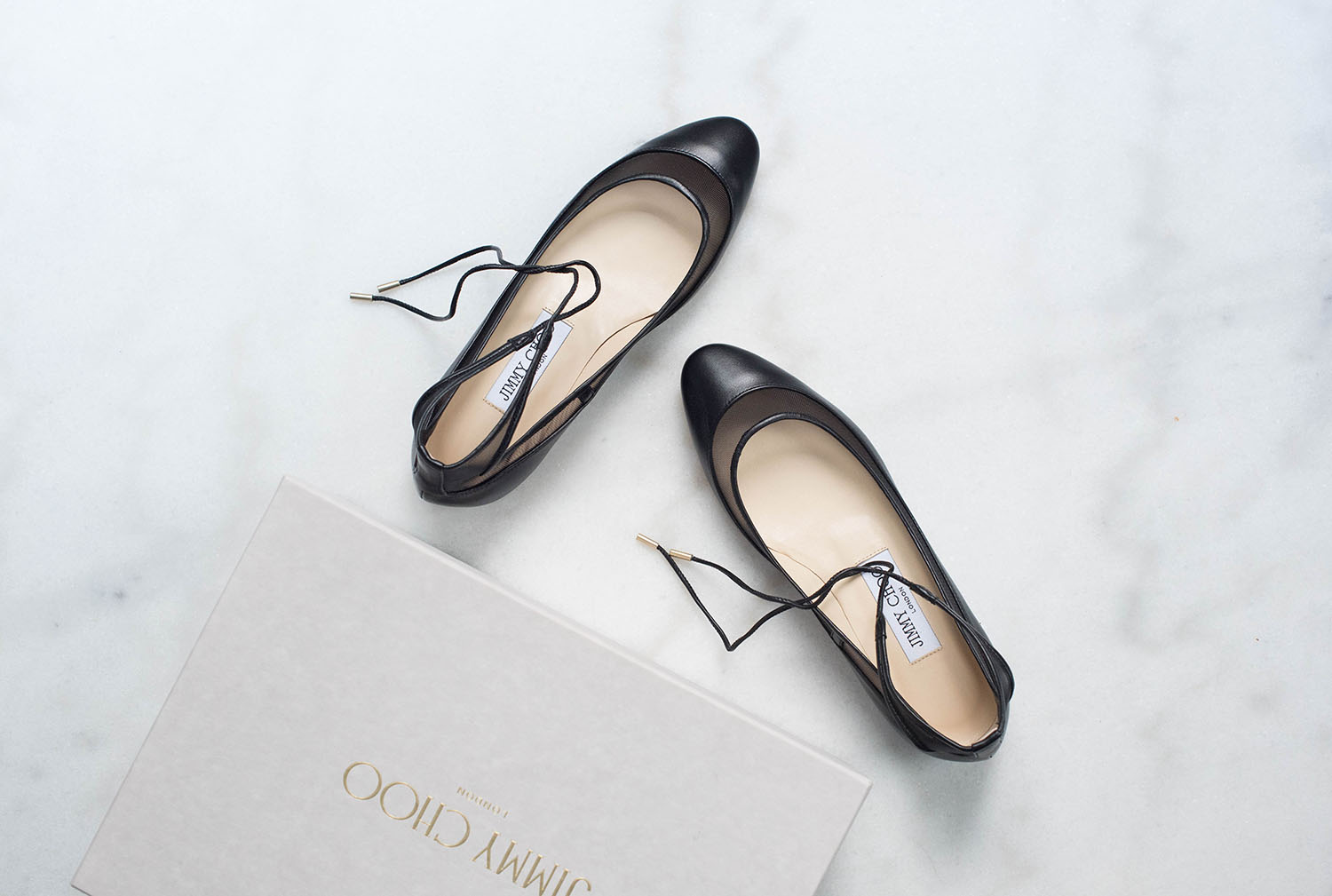 Coco & Vera - Jimmy Choo flats on a white marble background